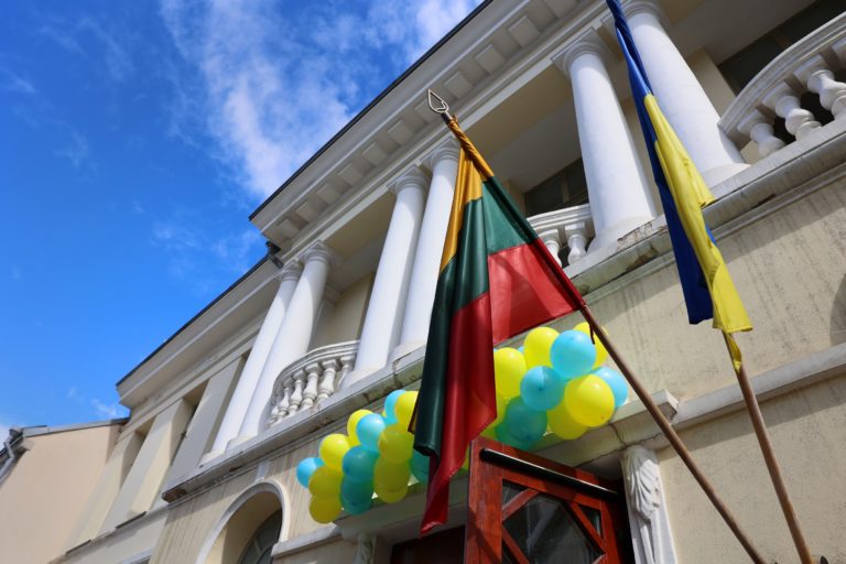 Bibliotekos pastato fasadas, papuoštas balionais ir vėliavomis