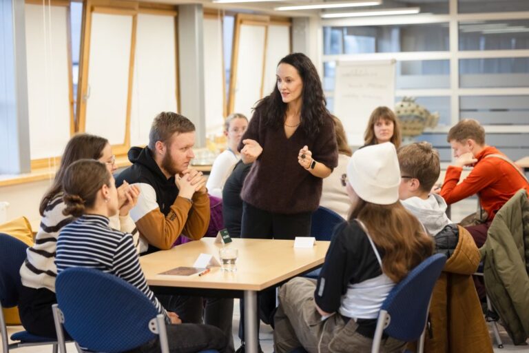 Panevėžio jaunimas bibliotekoje atrado savo galimybių kodą Jaunuoliai sėdi už stalų bibliotekos skaityklos fone