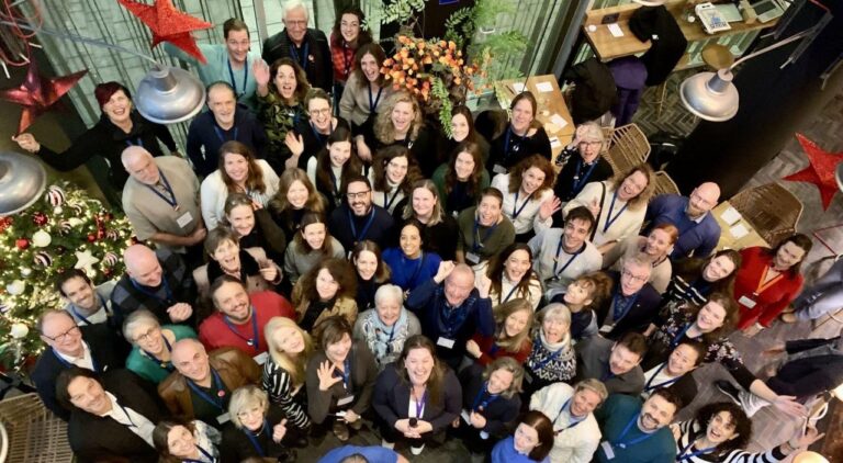 Big group of smiling participants